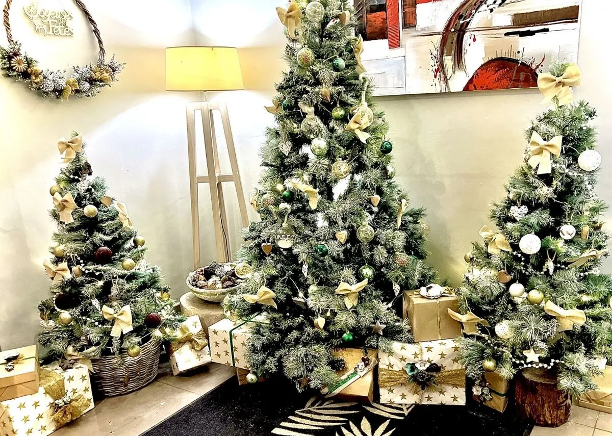 Décoration de Noël avec sapins, paquets cadeaux et éléments naturels pour entrée de restaurant d’hôtel en Martinique